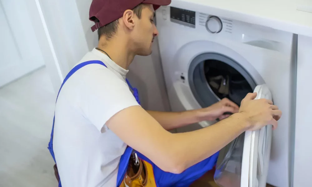 handyman-fixing-washing-machine-bathroom